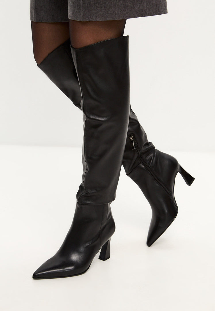 A stylish pair of black knee-high boots, also known as Classic Iris Boots, perfect for any outfit.