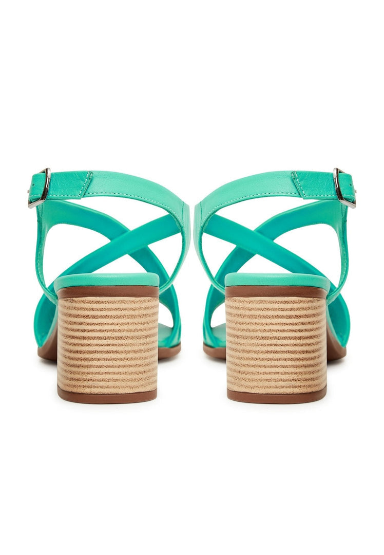 A stylish pair of green block heel sandals, perfect for adding a pop of color to your casual outfit.