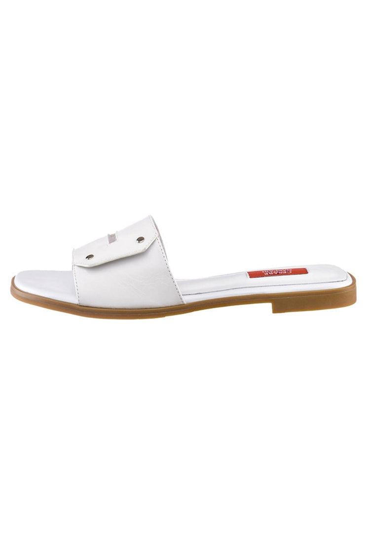 A woman wearing elegant white chic sandals, a trendy and stylish choice for a fashionable look.