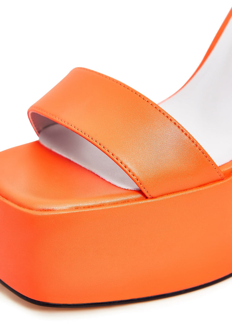A pair of elegant orange high heel sandals, perfect for women's fashion, showcasing sophisticated footwear.