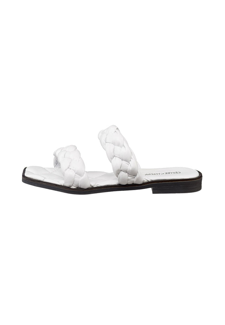 A pair of high quality soft leather white flat sole sandals, perfect for all-day comfort and style.