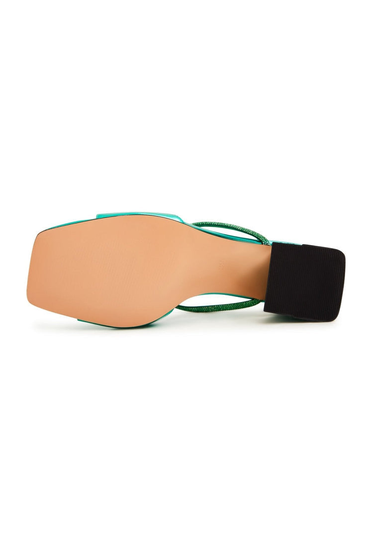 A pair of chic green backless heels, the perfect statement shoes for any outfit, reminiscent of the Rosalia heels.