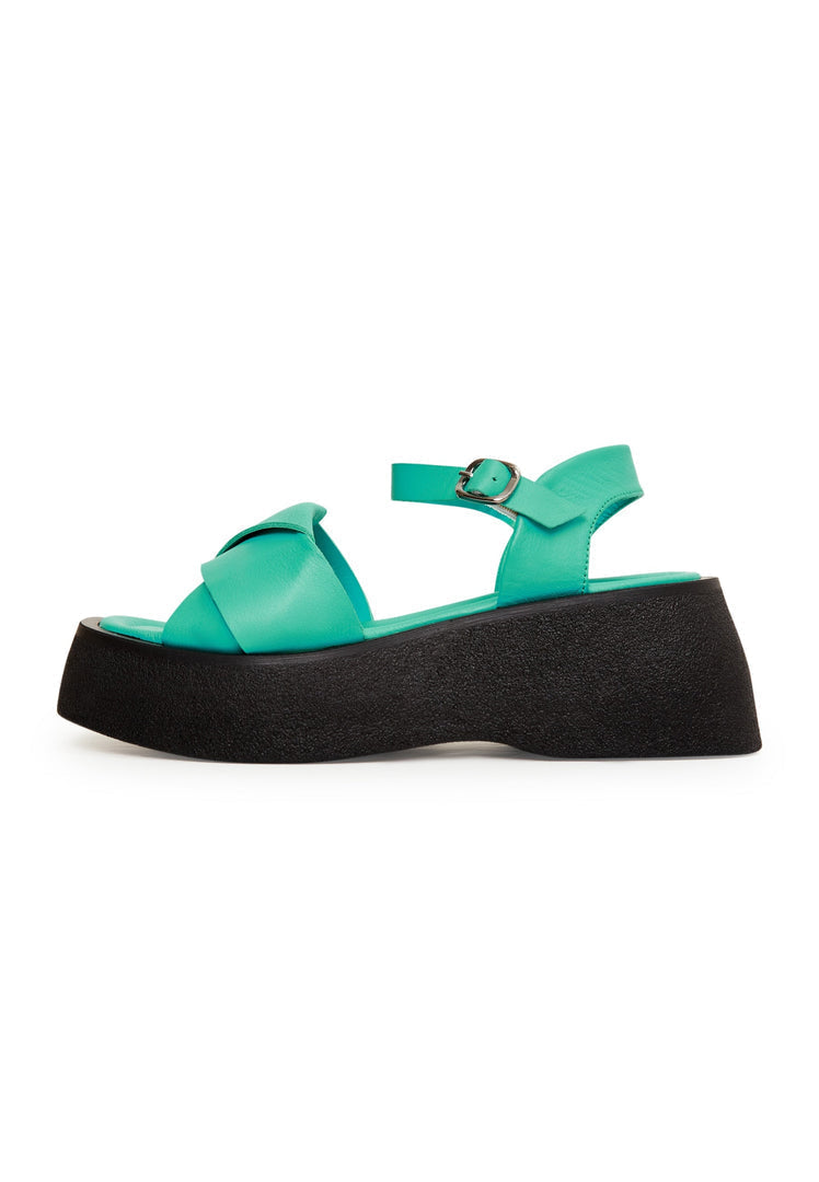 A stylish pair of women's green leather platform sandals, featuring high heels, perfect for fashionable women looking for chic green footwear.