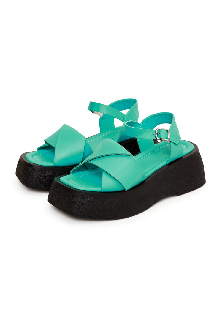 A stylish pair of green leather platform sandals for women, featuring high heels and a fashionable design. Ideal footwear choice for women seeking trendy green sandals.