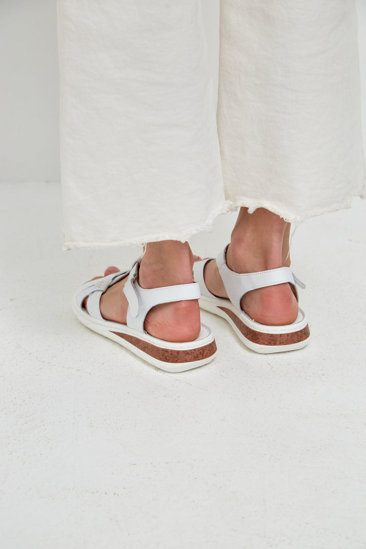 A stylish pair of leather platform heels for women, featuring urban sandals with high heels and a trendy platform design.