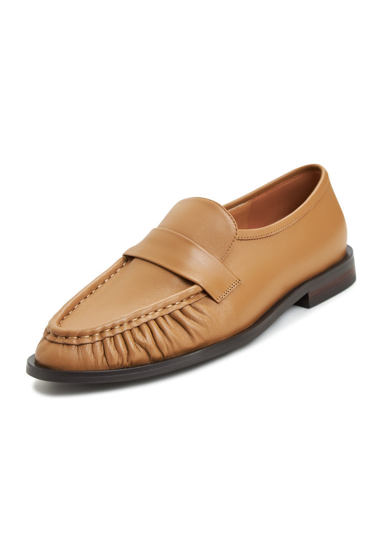 A pair of classic beige leather loafers for women, the Isabel shoes - timeless and elegant footwear.