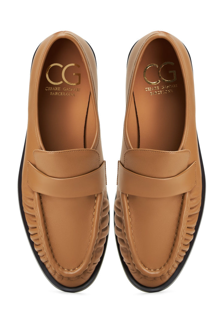 A classic pair of beige leather loafers named Isabel, perfect for women's style with timeless elegance.