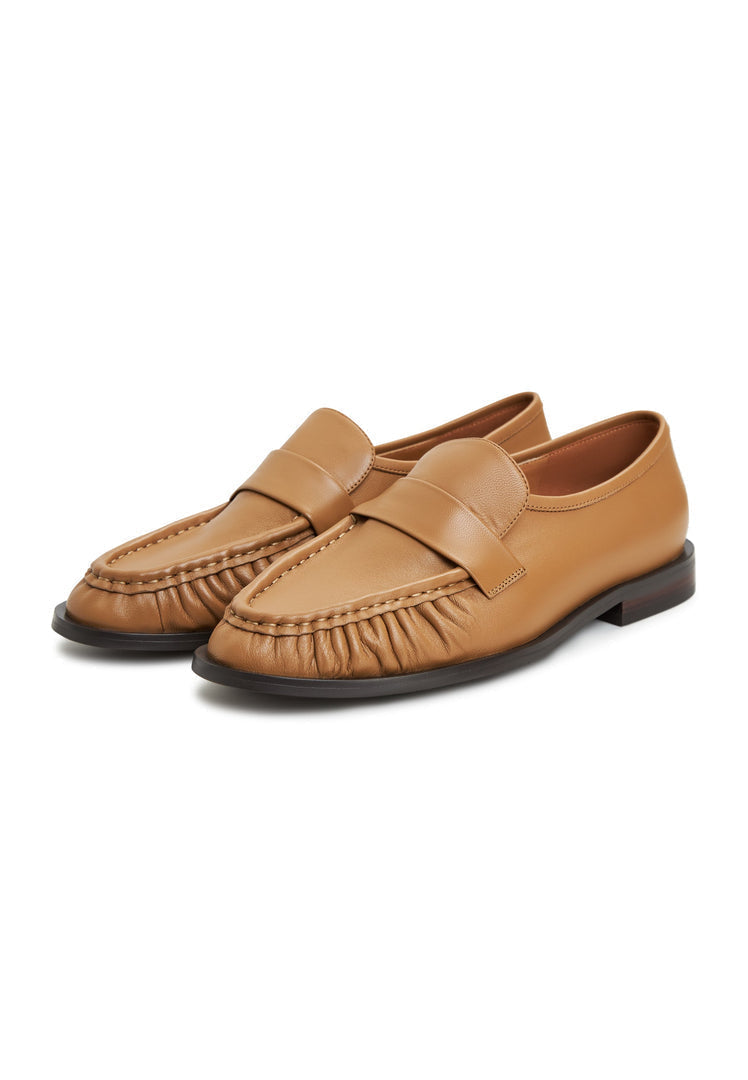 A stylish pair of Isabel beige leather loafers, classic footwear for women.