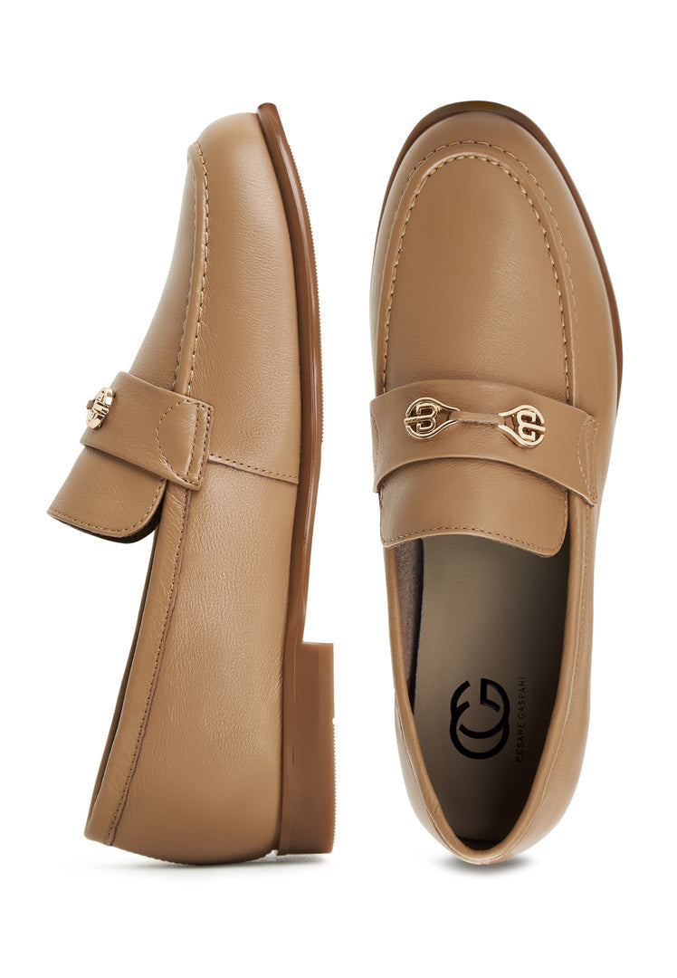 A pair of trendy beige Abigail leather block heeled loafers for women.