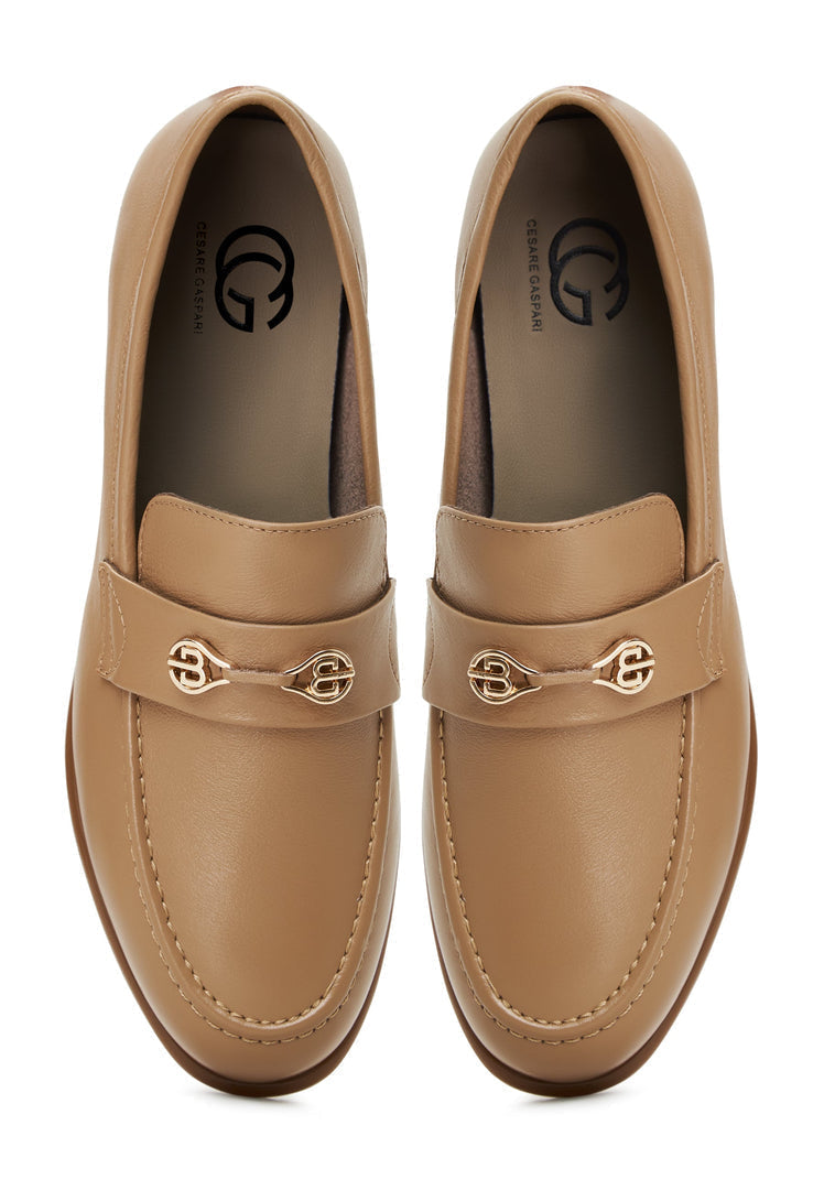 A stylish pair of women's beige leather block heeled loafers, known as the Abigail loafers, featuring a trendy block heel design.