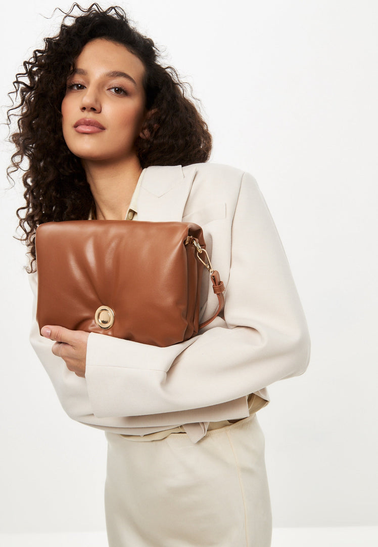 A stylish and timeless brown quilted clutch bag, perfect for adding a touch of elegance to any outfit.