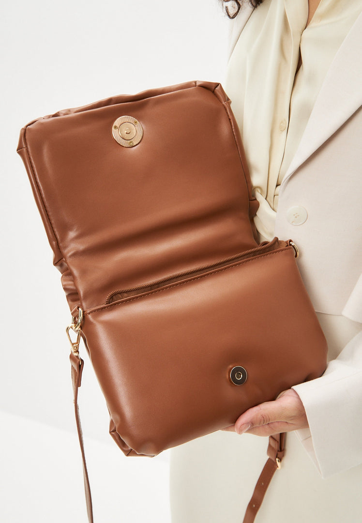 A stylish brown quilted clutch bag, perfect for adding a touch of elegance to any outfit.
