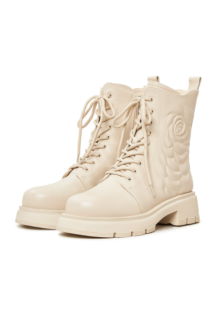 A pair of stylish women's ivory leather platform ankle boots with high heels.