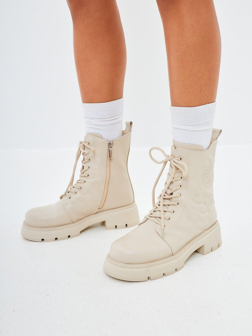 A pair of stylish leather platform ankle boots in ivory, perfect for women seeking high heel fashion.
