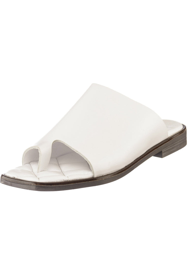 A pair of comfortable minimalist flat sole one toe loop sandals in a neutral color.