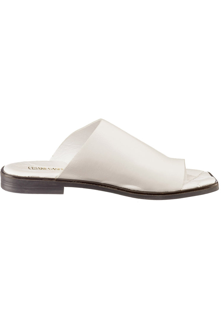 A close-up image of a pair of comfortable flat sole minimalist sandals with a chic one toe loop design.