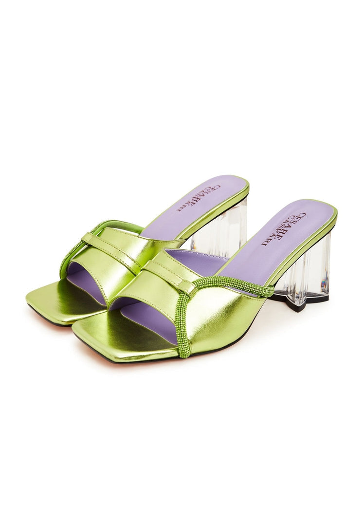 A pair of stylish green block heel mules for women with unique star-shaped heels, perfect for a fashionable look.