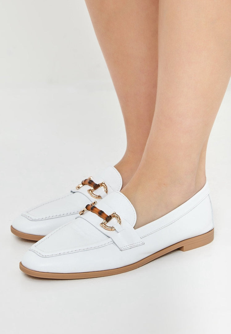 A stylish pair of high-quality leather white loafers, perfect for any occasion, designed by a renowned luxury shoe brand.