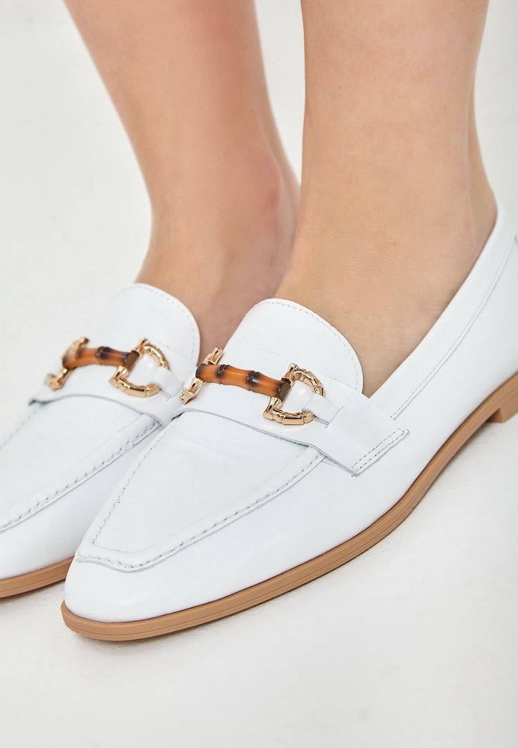 A pair of high-quality white leather loafers, perfect for any stylish outfit.