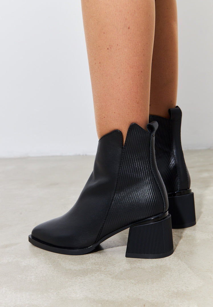A stylish and affordable pair of women's black suede ankle boots perfect for everyday wear.