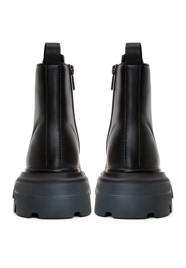 A stylish pair of designer lace-up leather booties, showcasing high-end, luxe footwear.