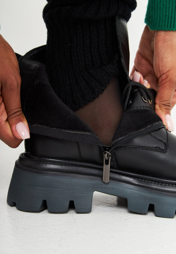 A fashionable pair of designer lace-up leather booties, the epitome of luxe footwear and high-end shoes.