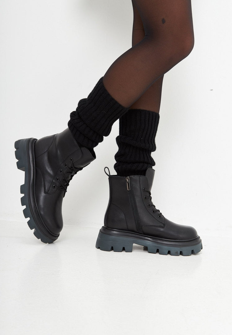 A close-up image of designer lace-up leather booties, showcasing the luxe craftsmanship of these high-end shoes.