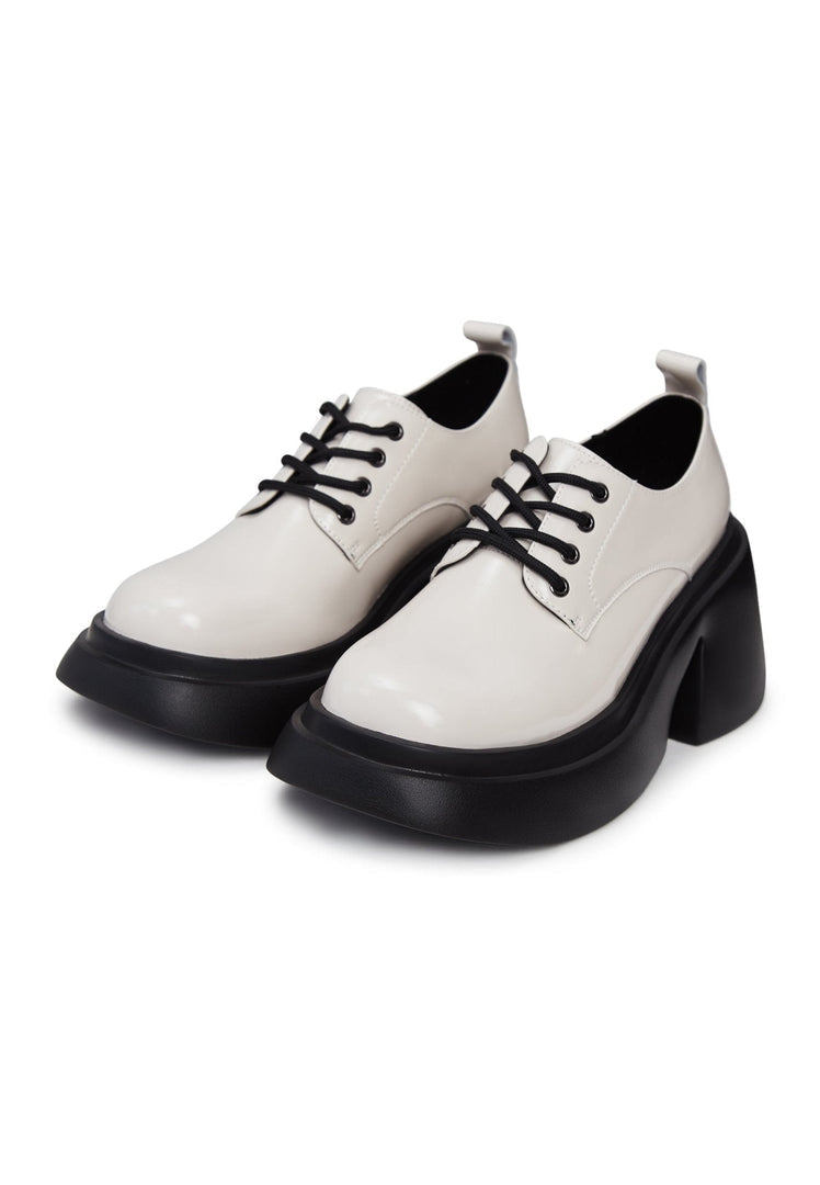 A pair of stylish chunky white loafers, perfect for fashion-forward women's footwear.