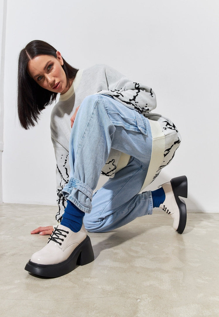 A stylish pair of white chunky loafers, perfect for any fashion-forward woman's wardrobe.