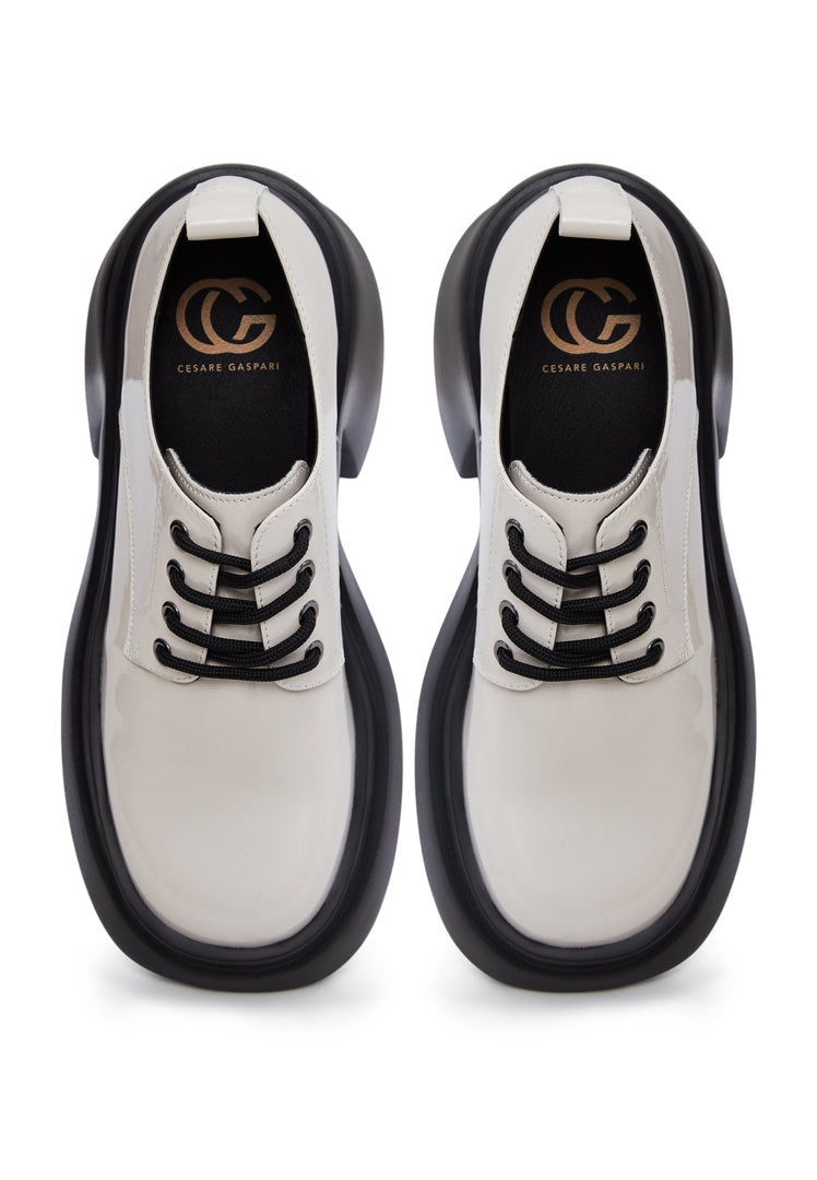 A trendy pair of chunky white loafers, perfect for a fashion-forward woman's shoe collection.