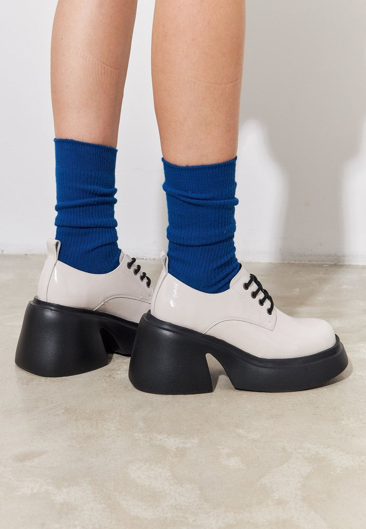 A stylish pair of chunky white loafers, perfect for the fashion-forward woman.