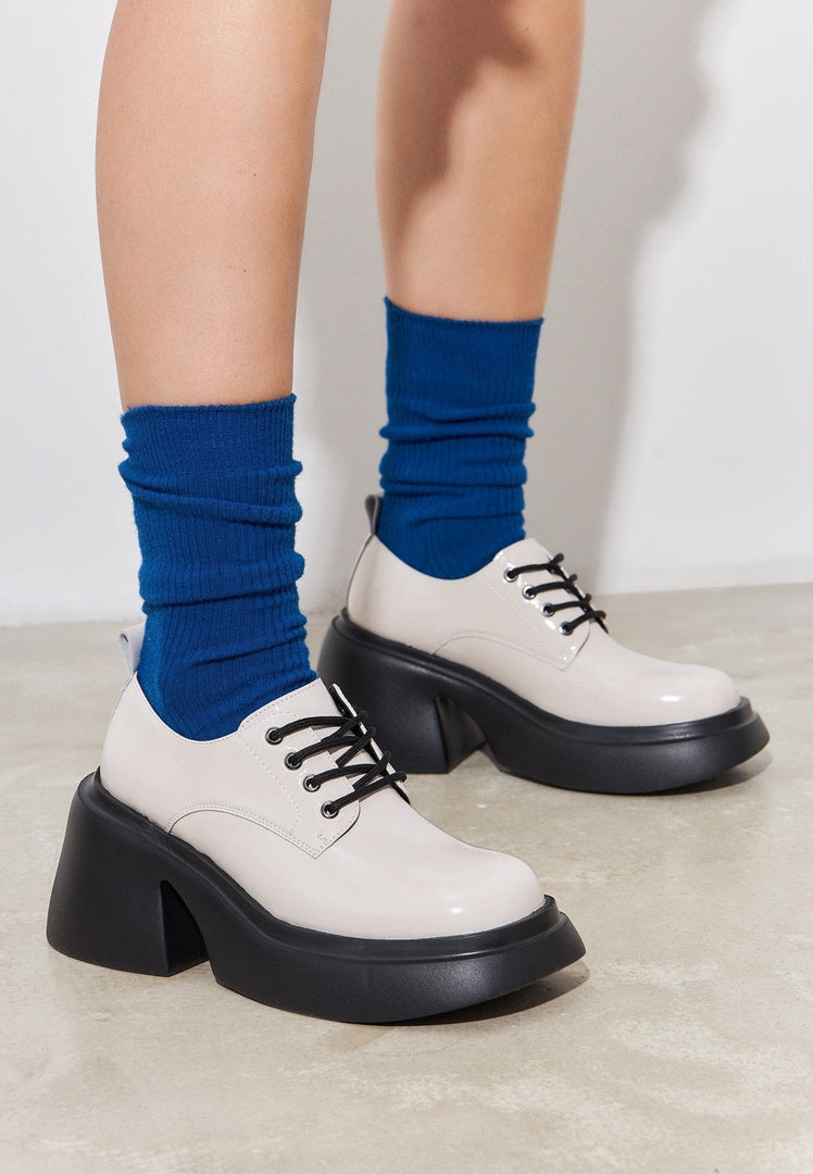 A trendy pair of white chunky loafers, fashion-forward women's shoes perfect for any outfit.