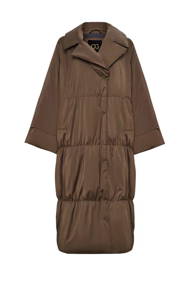 A stylish plus size model wearing a trendy long oversized puffer coat for extra warmth and style in winter fashion.