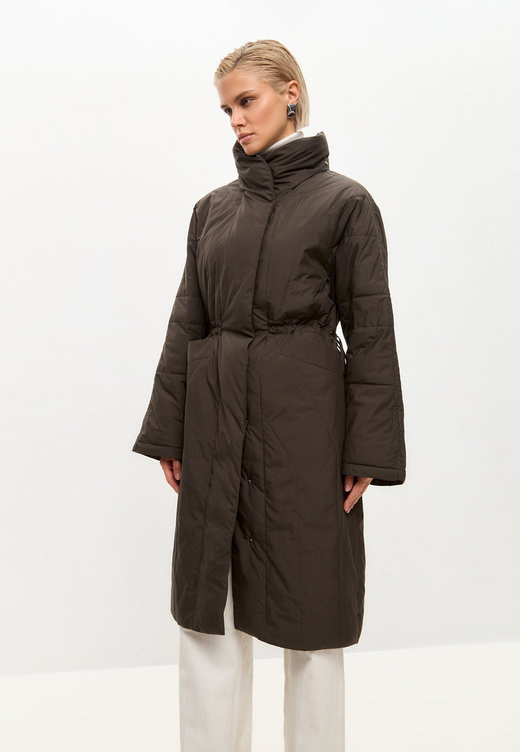 A fashionable long quilted brown winter jacket for women, the perfect puffer coat in women's quilted outerwear.