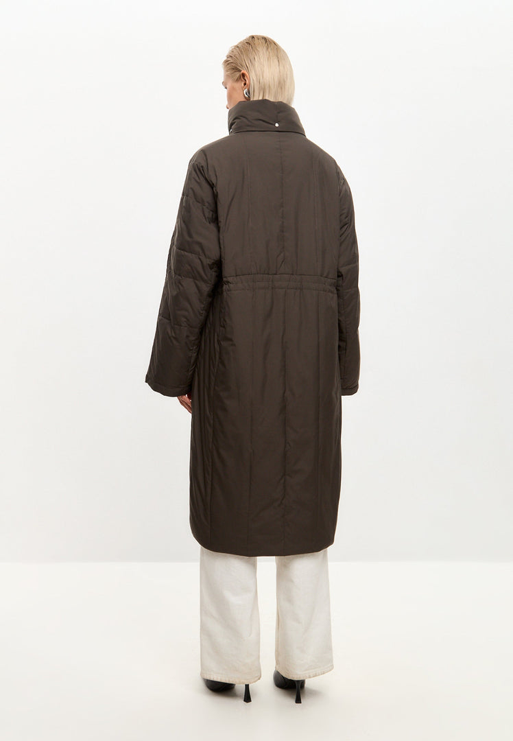 A fashionable long quilted puffer coat in brown, ideal as women's quilted outerwear for the winter season.