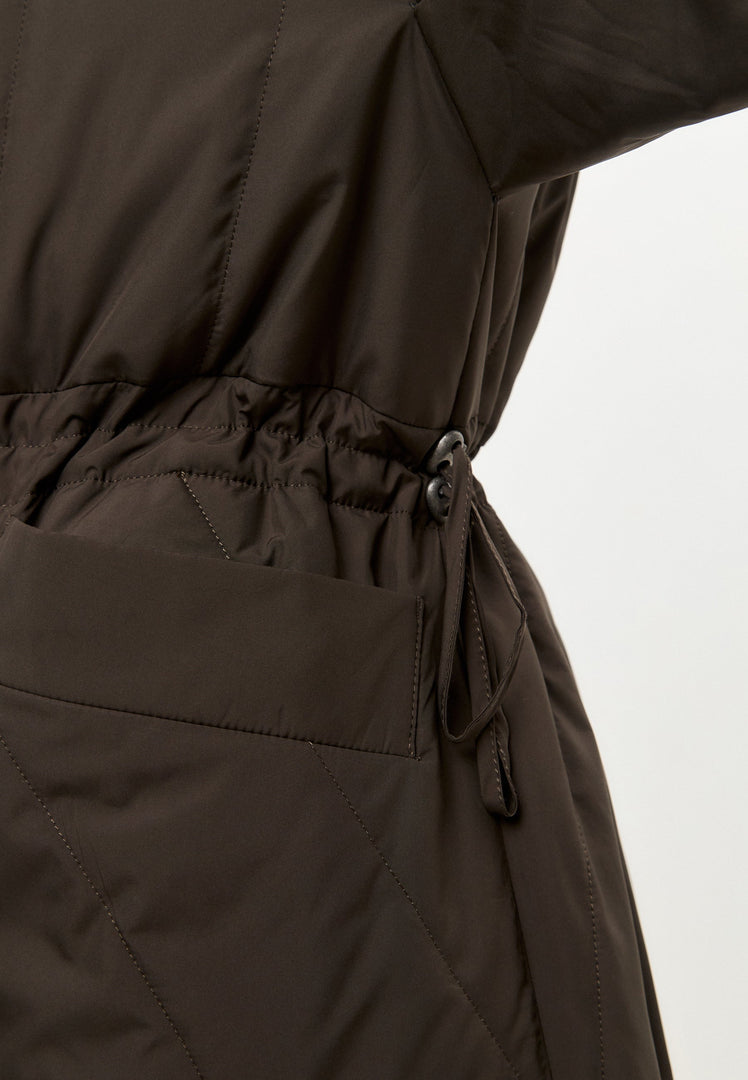 A fashionable long quilted brown winter jacket, perfect women's outerwear for staying warm and stylish in cold weather.