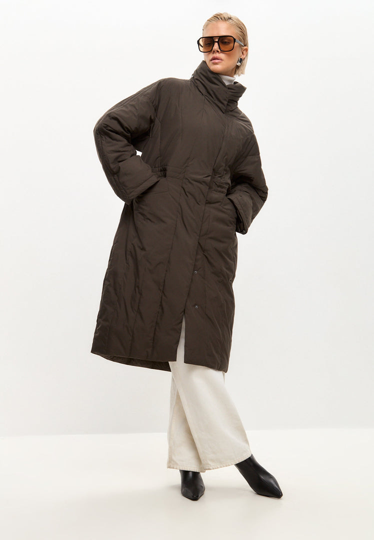 A fashionable long quilted brown winter jacket for women, perfect for staying warm in style.