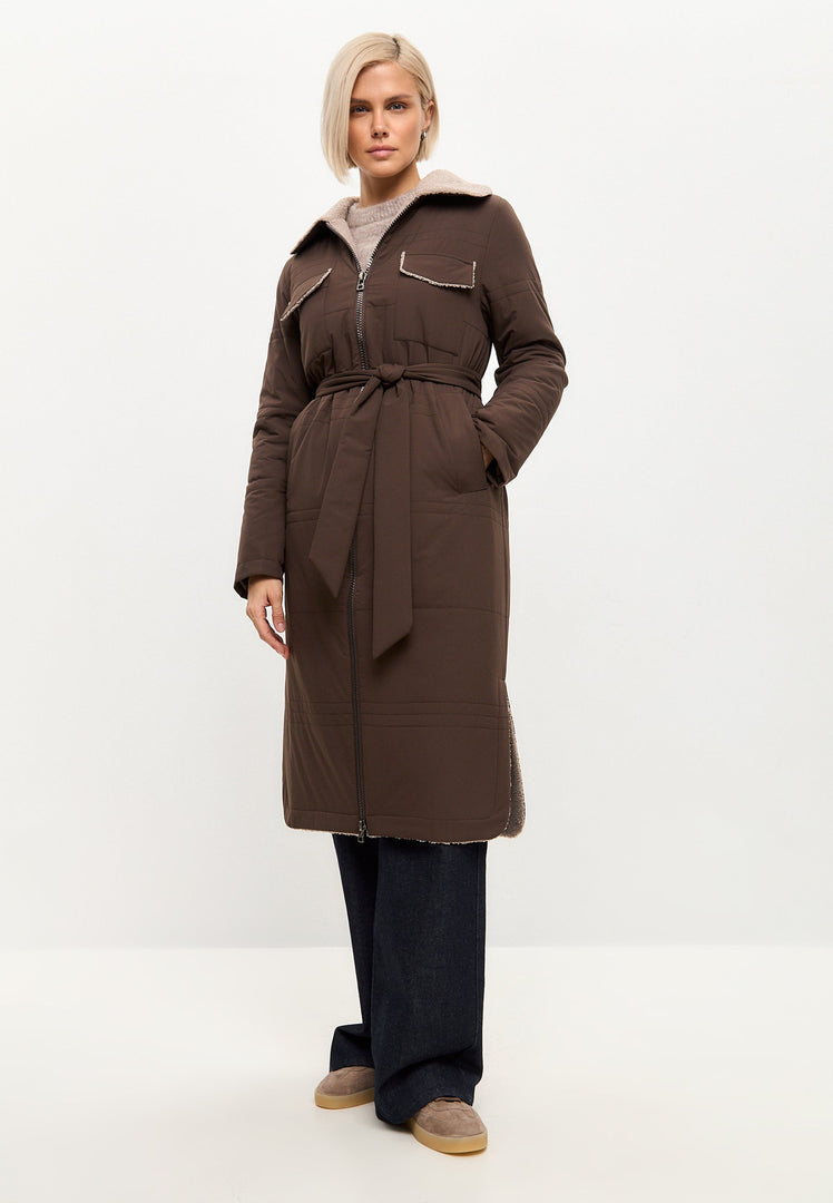 A stylish belted shearling coat with a long coat and shearling collar, perfect for winter and on-trend fashion.