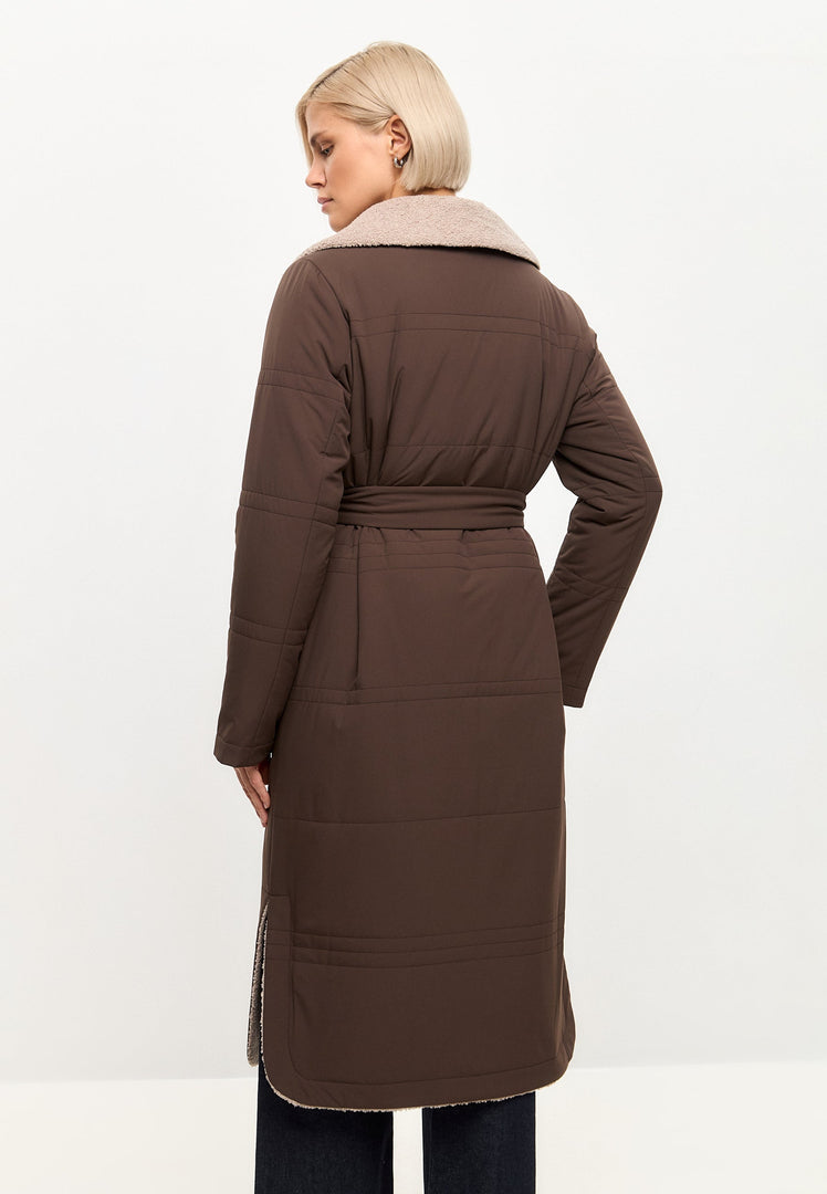 A trendy and stylish belted shearling coat with a luxurious collar, perfect for winter fashion.