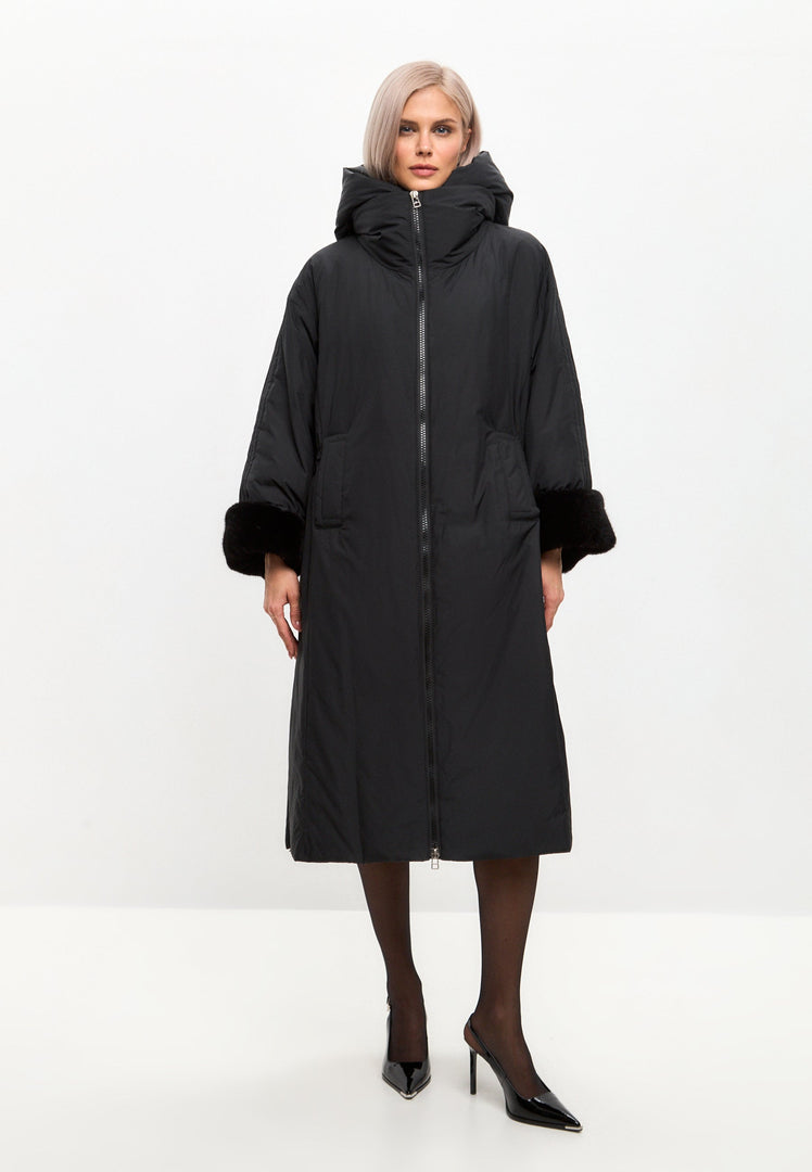 A stylish black oversized puffer coat with a hood, faux fur cuffs, and designed as plus size outerwear in the latest women's fashion trends.