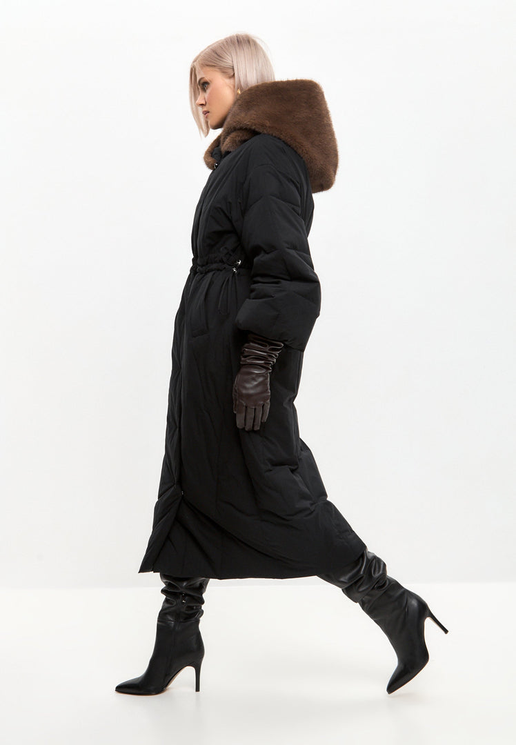 A stylish woman wearing a luxury winter coat, a hooded high-end winter jacket that is a fashionable parka, showcasing exquisite designer outerwear.