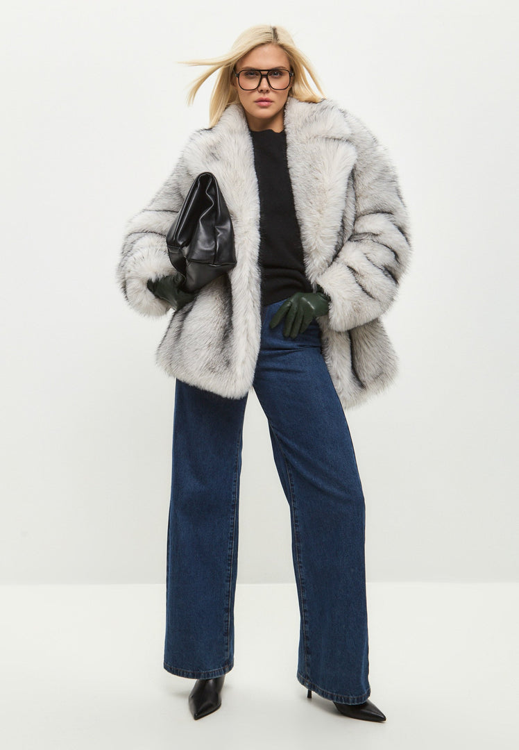 A fashionable and elegant white faux fur coat, the epitome of chic outerwear and trendy winter fashion.