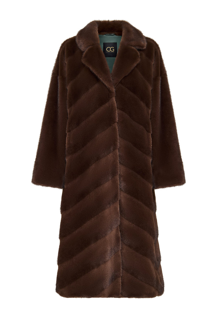 A stylish woman wearing an oversized brown faux fur coat, the perfect trendy statement piece for winter fashion in women's outerwear.