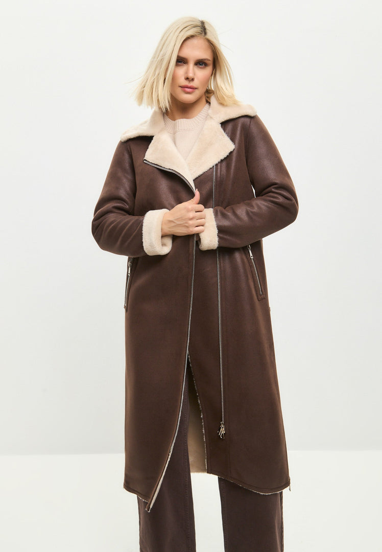 A stylish woman in a luxurious brown faux fur coat that can be reversed to reveal a cozy shearling lining, a versatile and trendy long shearling jacket perfect for winter, the ultimate brown faux fur outerwear that exudes elegance, and a must-have shearling coat for women.