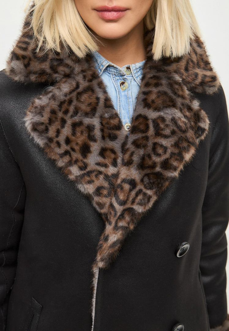 A stylish and trendy reversible long faux shearling coat with an animal print design, perfect for staying cozy and fashionable in the winter.