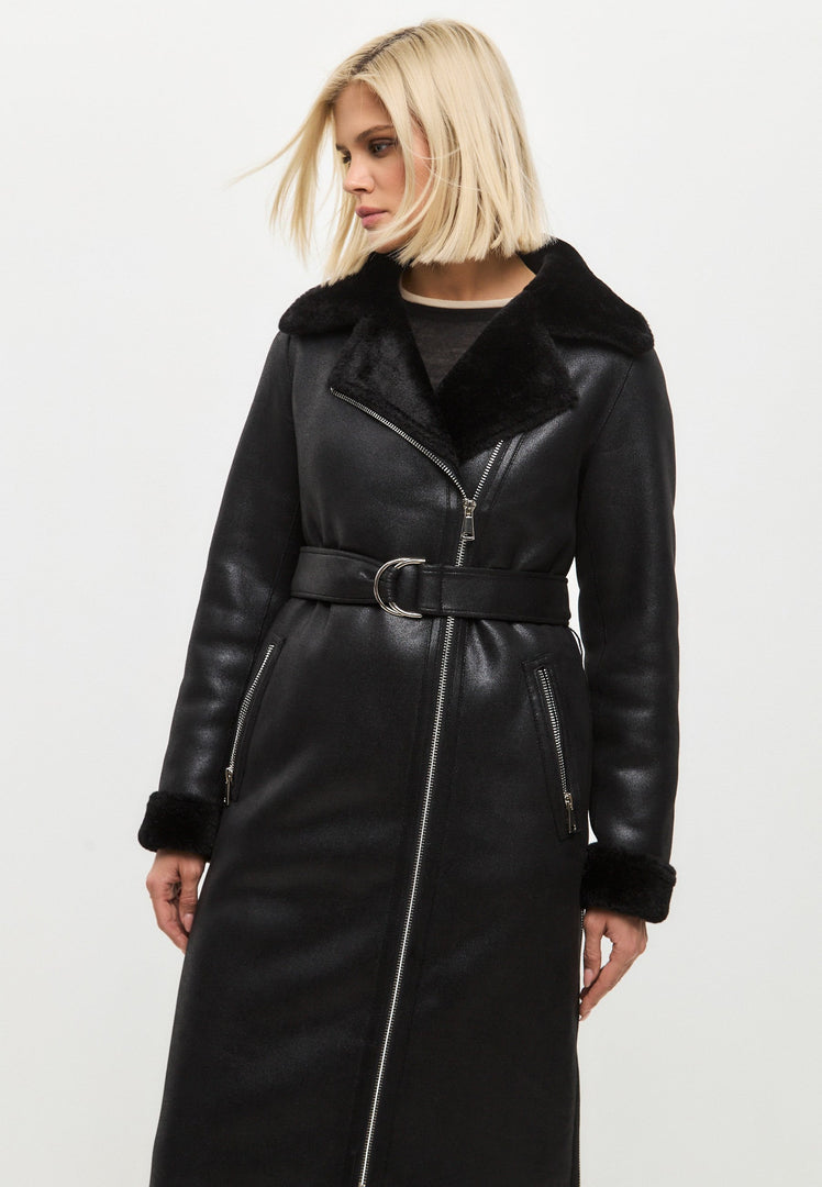 A stylish black shearling coat, a reversible long faux shearling jacket, ideal for women's winter outerwear, showcasing trendy shearling clothing.