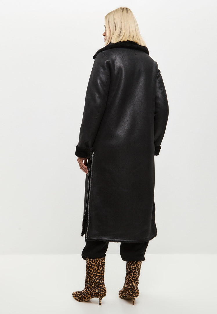A stylish black shearling coat for women that is both fashionable and warm, perfect for the winter season.
