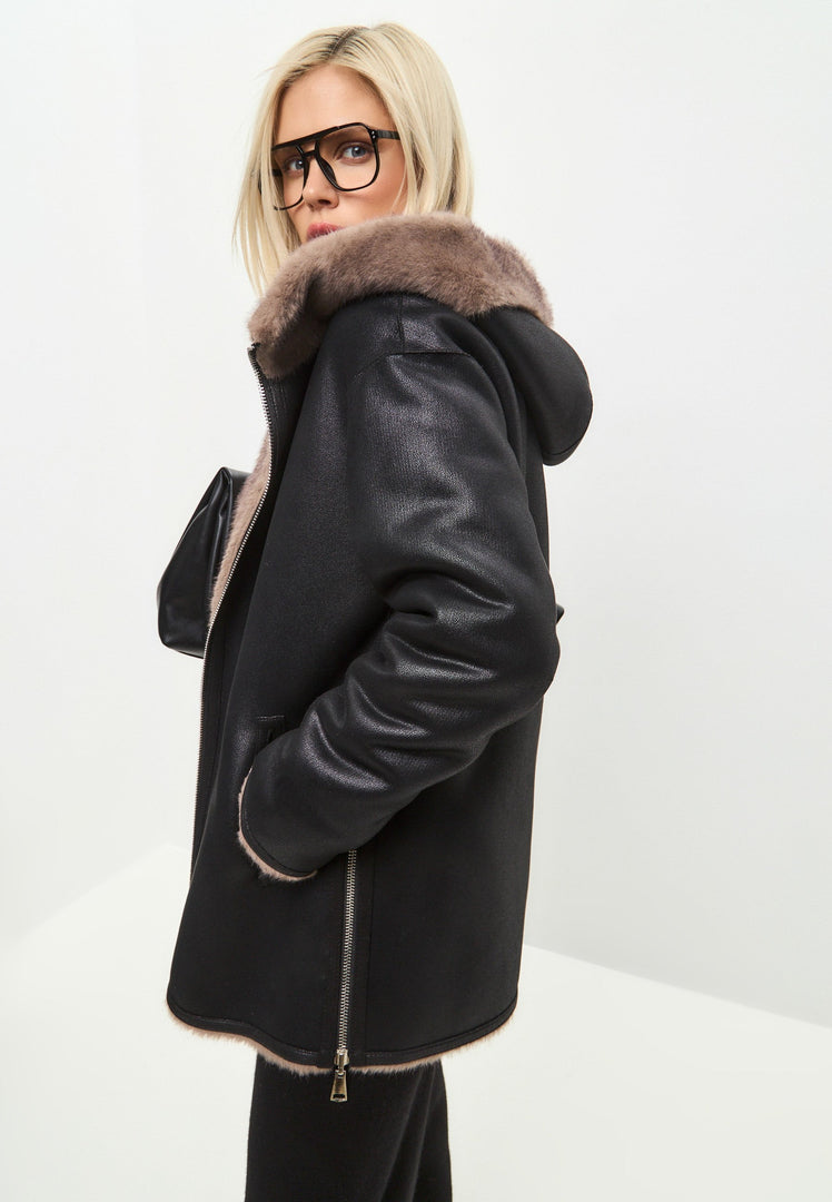 A trendy reversible faux leather jacket with faux fur trim, a stylish vegan leather jacket with fur details, perfect for fashionable outerwear options.
