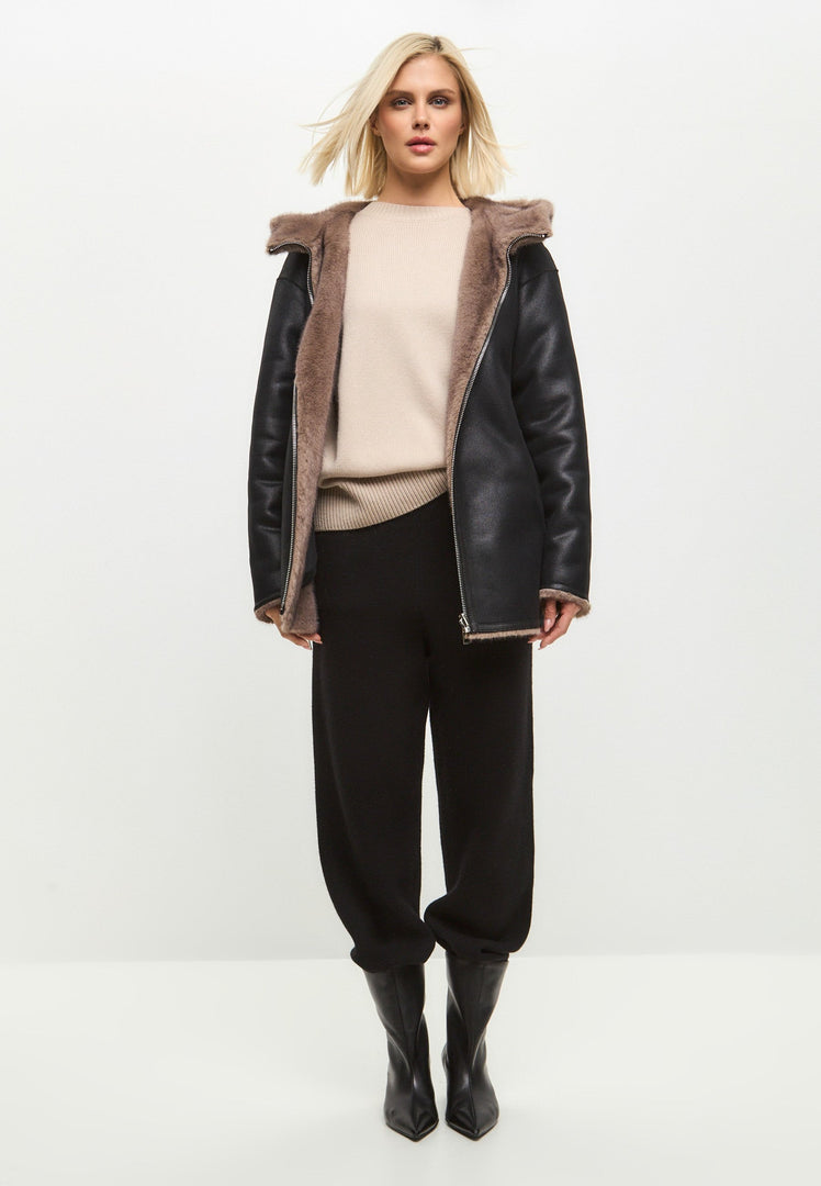 A trendy reversible faux leather jacket with faux fur trim, the perfect stylish and vegan outerwear option.