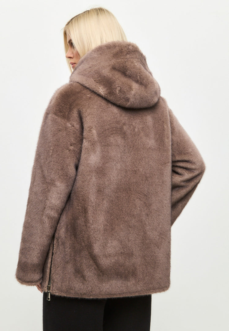 A stylish reversible faux leather jacket with faux fur trim, perfect for fashion-forward individuals looking for trendy vegan leather outerwear with luxurious fur details.